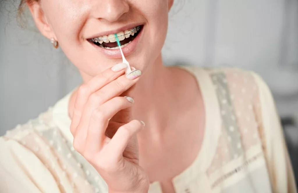 young-woman-with-braces-teeth-using-elastic-cleaning-toothpick_651396-3443.jpg