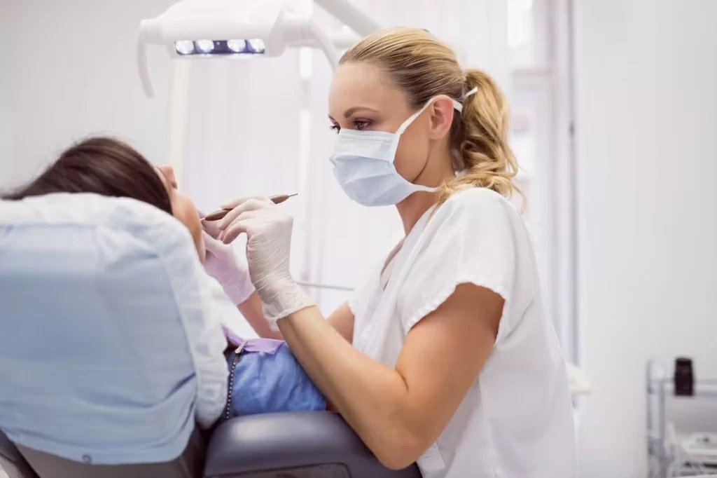 dentist-examining-female-patient_107420-65395.jpg